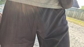 A large penis is visible from under his clothes while walking