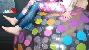 girl playing on big dotteed beachball