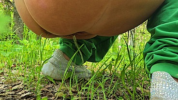 Mature MILF pisses in nature and masturbates sitting on a tree stump