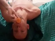 Skinny teen Deepthroating a big fat carrot while upsidedown (turn up the volume)