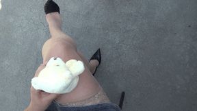 a small teddy bear sits astride my crossed legs CRF