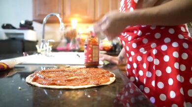 Hot mom shows off her big tits while making pizza