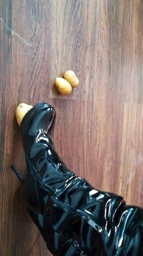 The lady in beautiful boots crushes potatoes