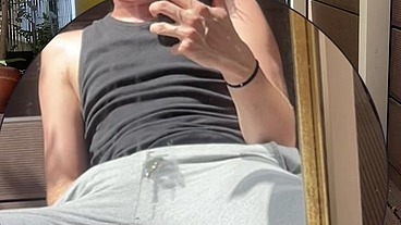 Amateur boy wets his grey sweatpants