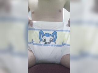 Pissing on an open diaper then puting it on
