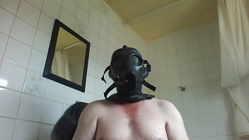 double masking , with rubber mask , helmet and a gasmask