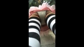 wetting pull-up in tutu and thigh-high socks outside