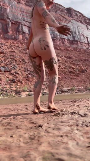 Mud-covered artist's model laughs at herself