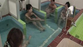 Japanese girls soak in the bath while a man touches them