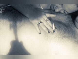 This guy smokes a cigarette and licks his lover's teats