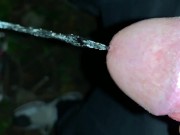 Slowmotion and close up - Unwashed uncut cock piss on the ground outdoor - long piss stream