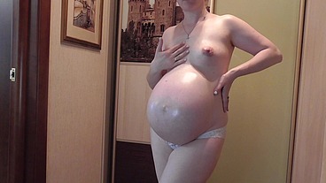 Gorgeous pregnant Anna massages her belly