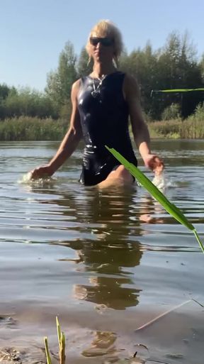 Trans girl swimming in the lake in blue sport dress. Wetllok trans girl wet.