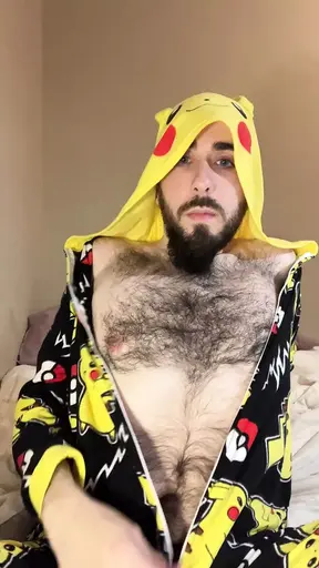 Bald bearded blue-eyed white otter in cute onesie pajamas strips down to tease very hairy ass with a gaming controller