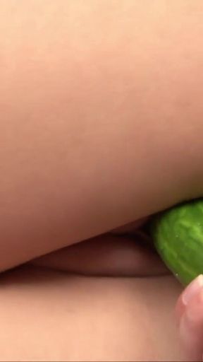 Three lesbians are playing with a cucumber