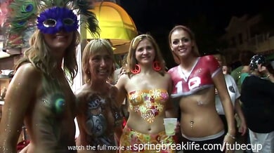 Blonde teens show off elaborate body paint at a Key West festival