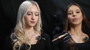 Two Women in Black Outfits Sharing a Cigarette with Slow Smoke and Playful Interaction