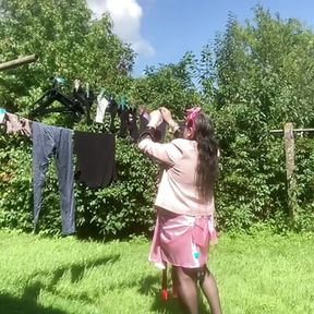 Hanging laundry in sexy pink skirt