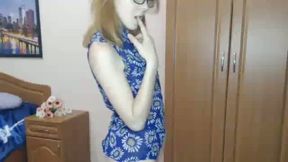 Beautiful Blonde Girl with Glasses Taking Off Her Clothes