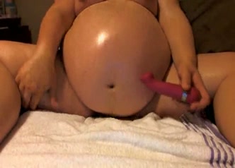 Heavily pregnant woman is fucking her ravenous cunt with her dildo on webcam