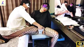 A mature Asian woman in her fifties gets dressed after a long day at work.