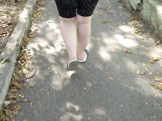 big beautiful woman in flip flops walks along the sidewalk whilst a voyeur peeps on her feet Public foot fetish