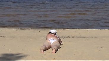 Nimble mature mommy has fun with young guys on the beach 2