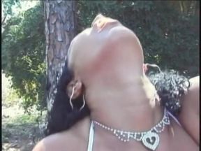 Babes by the trees lick twat and use dildo to fuck pussy after rim job