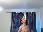 Skinny horny man attaches his big dildo onto his forehead and plays around with his cock