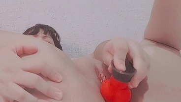 Girl sticking dildo inside pussy close up