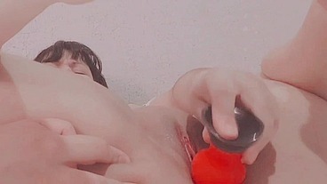 Girl sticking dildo inside pussy close up