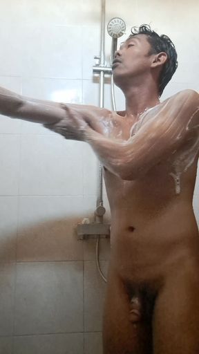 Exotic skinned Asian adult man taking a shower in the morning