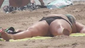 BBW mommy takes a sun bath on the beach