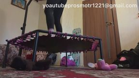 Nastya jumps on a Bossai trampoline, then puts on sneakers, jumps, and pushes it down. View from below. Under the trampoline is a toy car, and under the trampoline's feet are soft toys. leggings, legs, jumping, pushing, fetish,