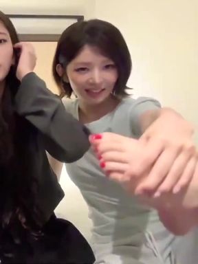 Slim couple enjoys foot play in a seated position