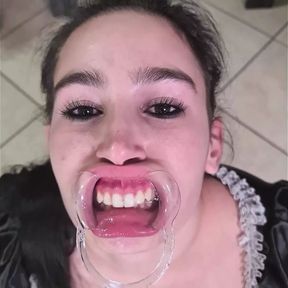 French maid tries to swallow her own piss through lip retractor