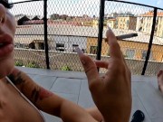 Two girlfriends smoke a cigarette