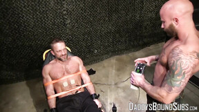 Sexy military guy Dirk Caber loves being tied up to a table & tormented