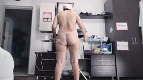 Sexy brunette doing naked chores around the house.