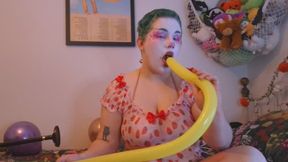 birthday clown has fun with balloons