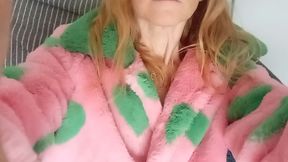 In a pink fur coat with green hearts
