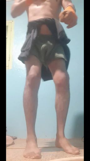 A sexy athletic man takes off his clothes and dances