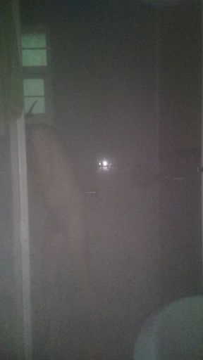 Man Showering with Flashlight On