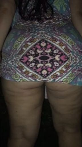 lifting up her dress on the street at night