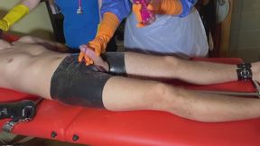 2 SADISTIC NURSES MILK PATIENT'S COCK WHILE HE'S BOUND IN A SPREADER BAR AND LATEX MITTENS