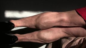 Pink Fox, lying on her side, flexing her calf muscles