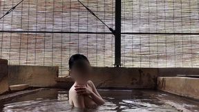 japanese girl bathing in a mixed outdoor bath at a hot spring inn