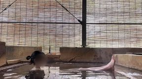 japanese girl bathing in a mixed outdoor bath at a hot spring inn