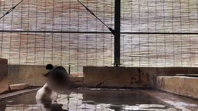japanese girl bathing in a mixed outdoor bath at a hot spring inn