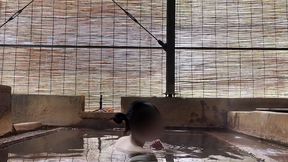 japanese girl bathing in a mixed outdoor bath at a hot spring inn